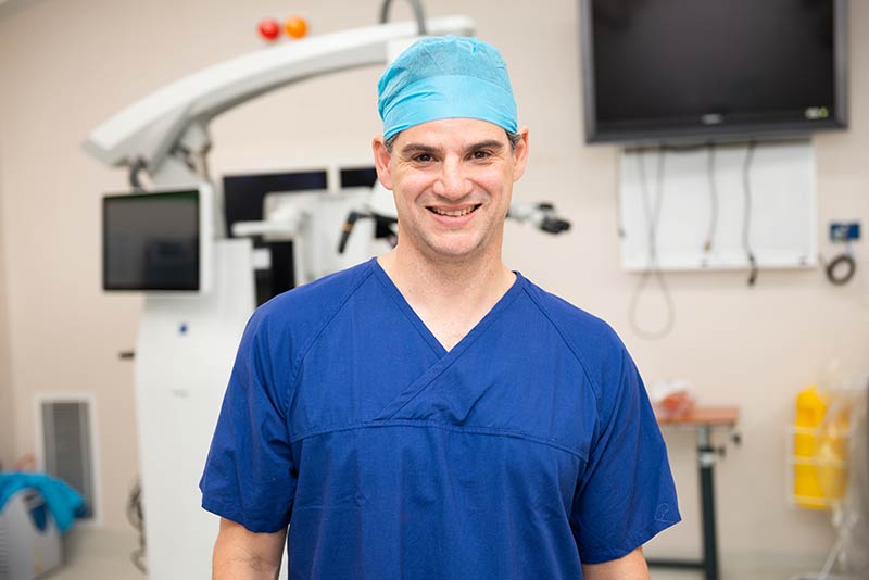 Dr Damian Amato, a Neurosurgeon at Pituitary Specialist Centre wearing surgical scrubs inside an modern operating theatre