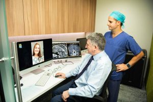 Dr Robert Campbell during Telehealth with a Pituitary Tumour patient in Brisbane with another neurosurgeon